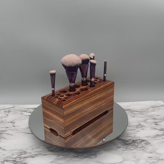 Video of a Zebrawood makeup storage box rotating on a leather round platform on a marble base